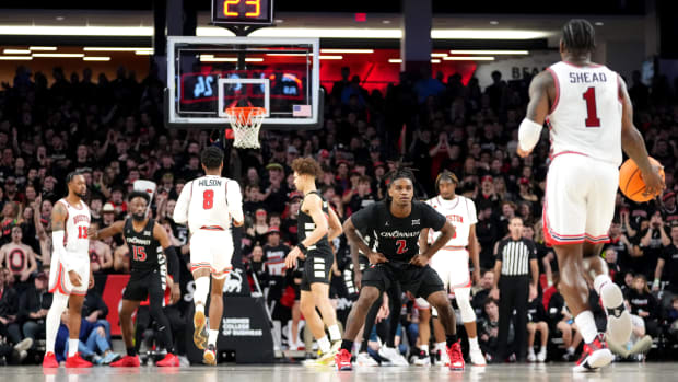 Cincinnati Bearcats guard Jizzle James (2) prepares to defend as Houston Cougars guard Jamal Shead (1) brings the ball down the court in the first half of an NCAA college basketball game between the Houston Cougars and the Cincinnati Bearcats, Saturday, Feb. 10, 2024, at Fifth Third Arena in Cincinnati.